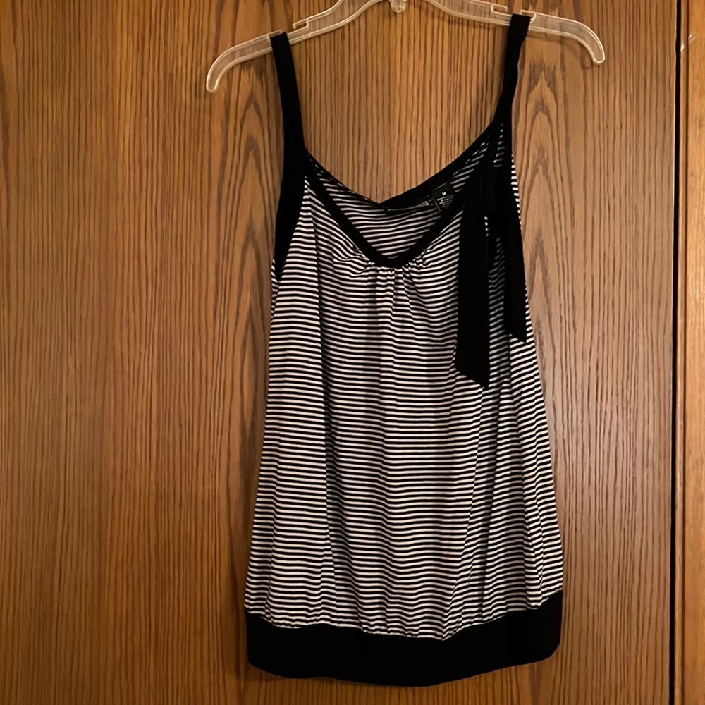 Medium top with bow on the left shoulder. Never worn